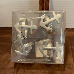 4 silver tone metal anchor napkin rings.